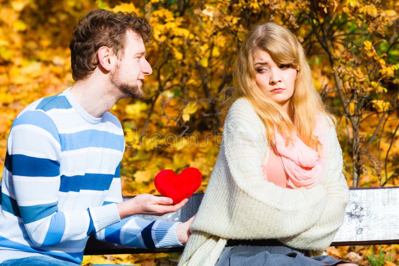 Romantic couple confessing love on a park bench